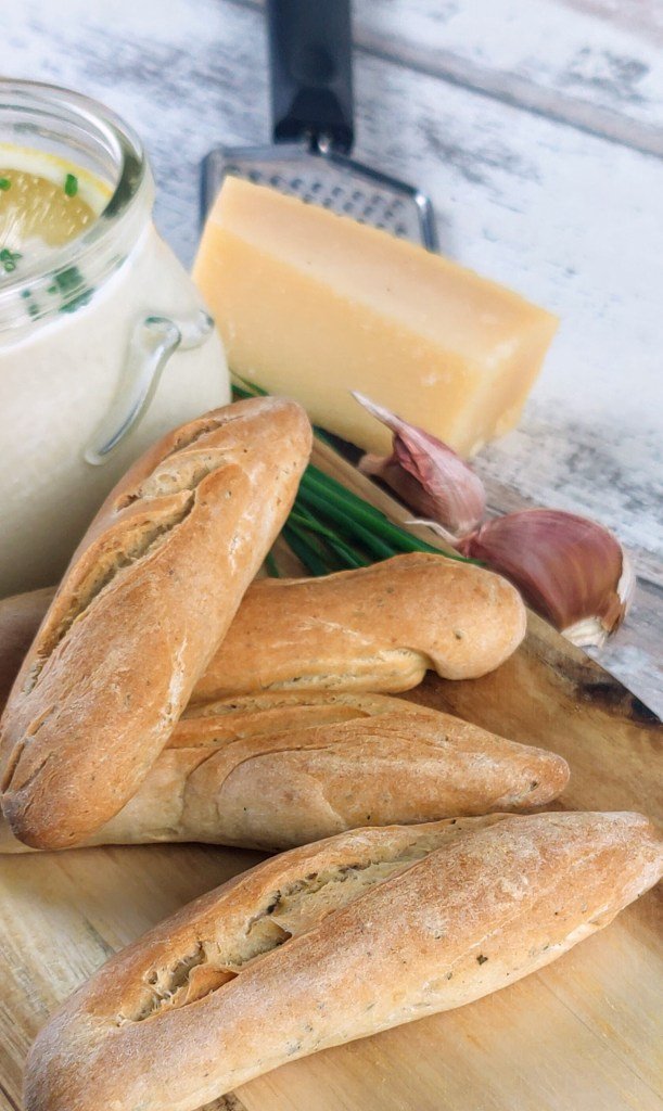 parmesan and herb breadsticks on a wooden board