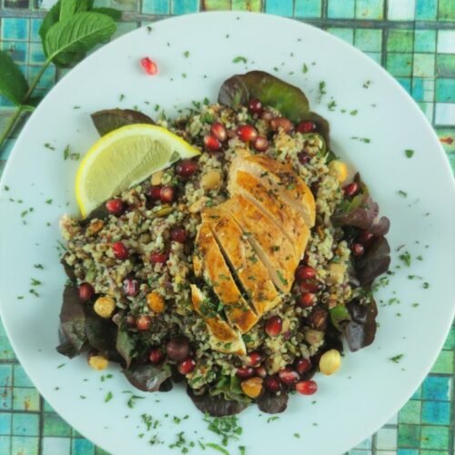 Colorful super grain salad with quinoa and barley, fresh vegetables, and herbs providing slow-burning complex carbohydrates for all-day vitality