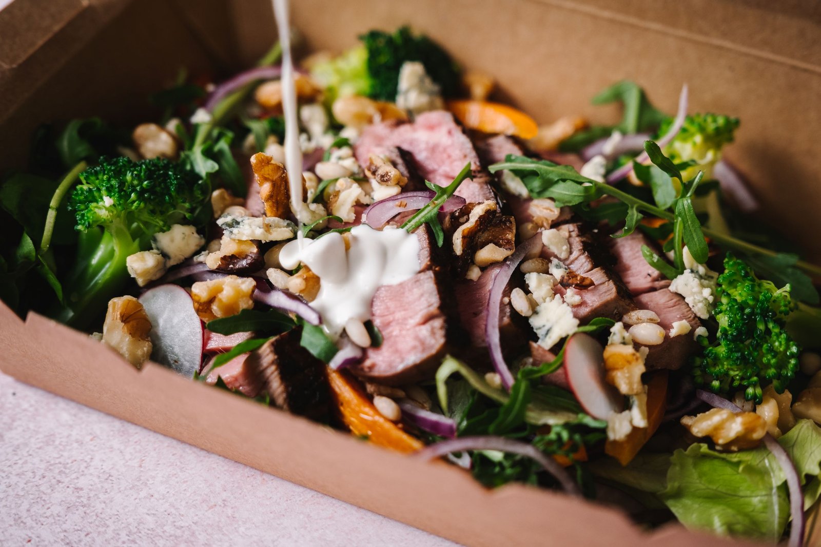Fillet Steak Salad on mixed leaves with red cabbage, broccoli, walnuts and served with blue cheese dressing