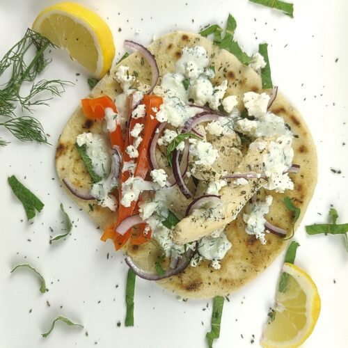 Greek chicken gyros wrapped in whole grain flatbread with fresh vegetables, lean protein for lasting fuel without afternoon slump