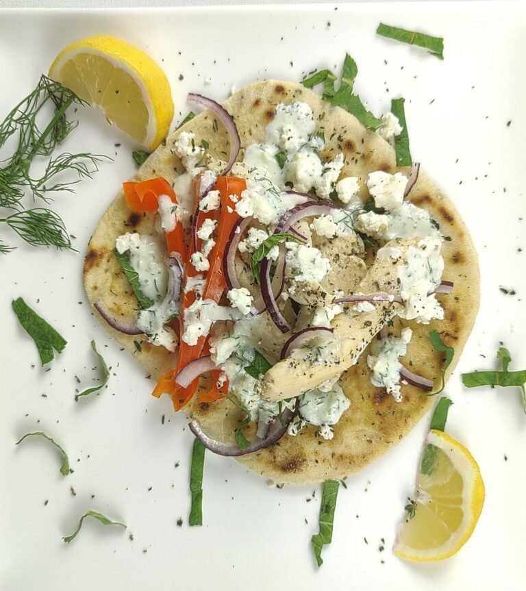 Greek chicken gyros wrapped in whole grain flatbread with fresh vegetables, lean protein for lasting fuel without afternoon slump