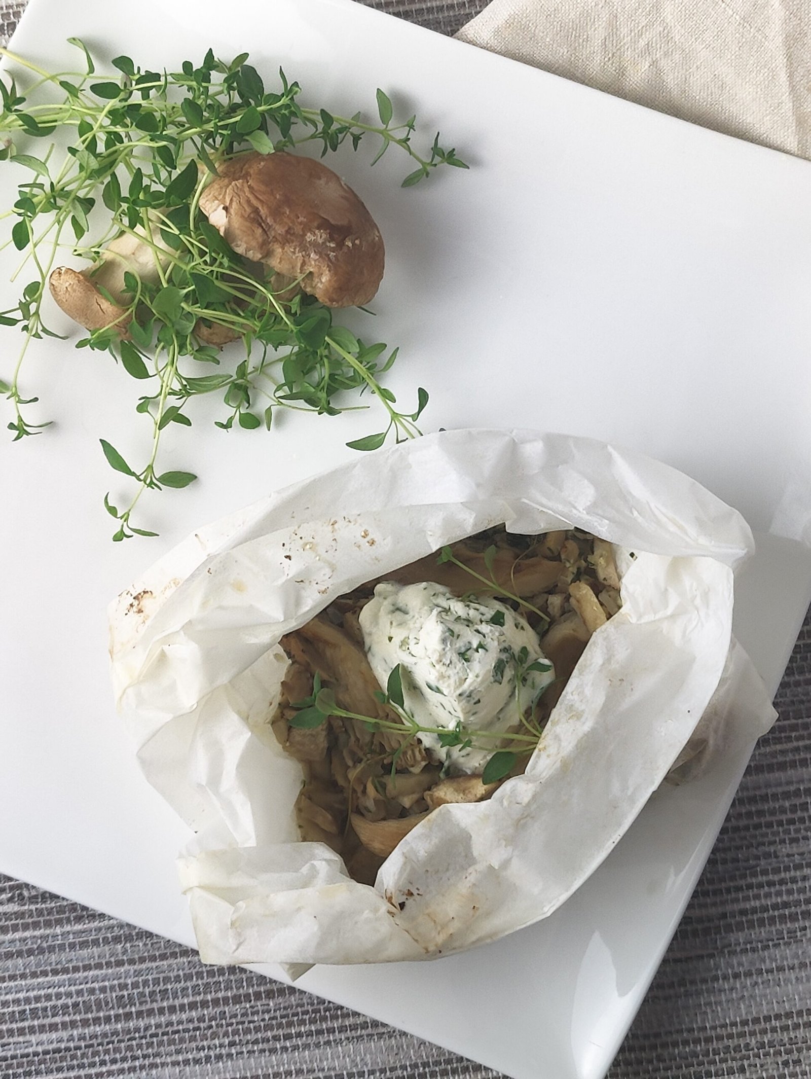 mushroom and thyme parcels on a white side plate with salad garnish
