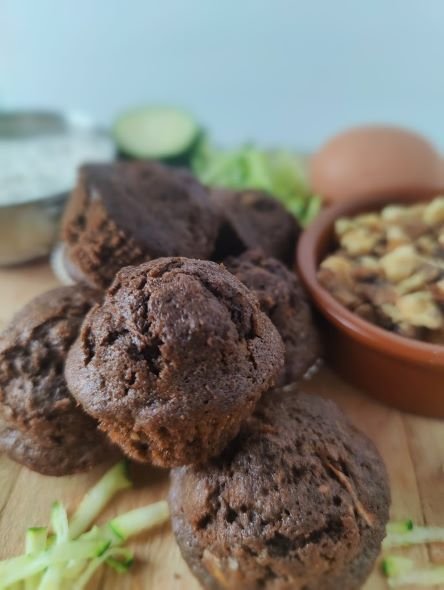 chocolate courgette mufins with walnuts on a wooden board