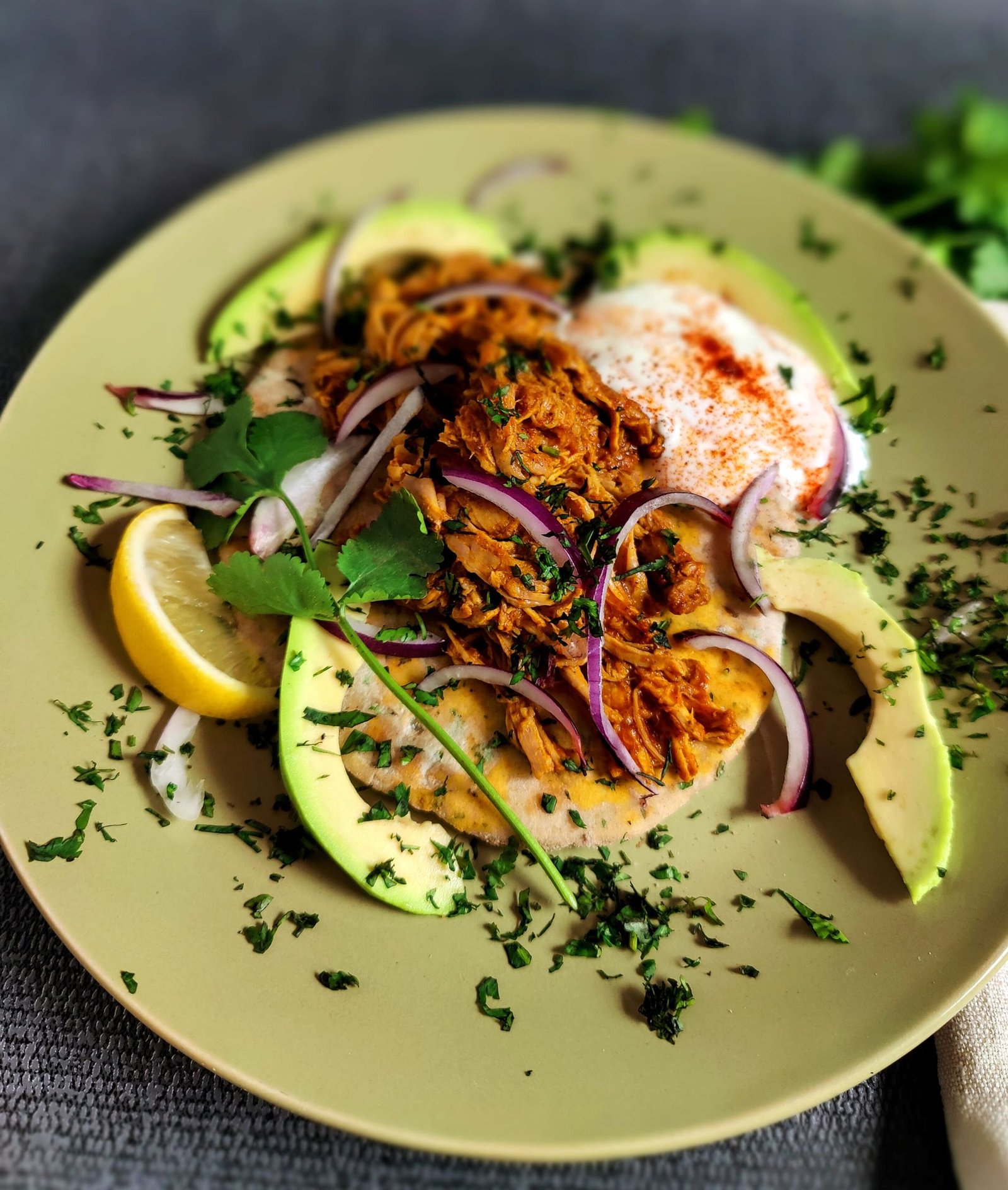 Pulled pork with avocado, mint, yoghurt and lemon wedge