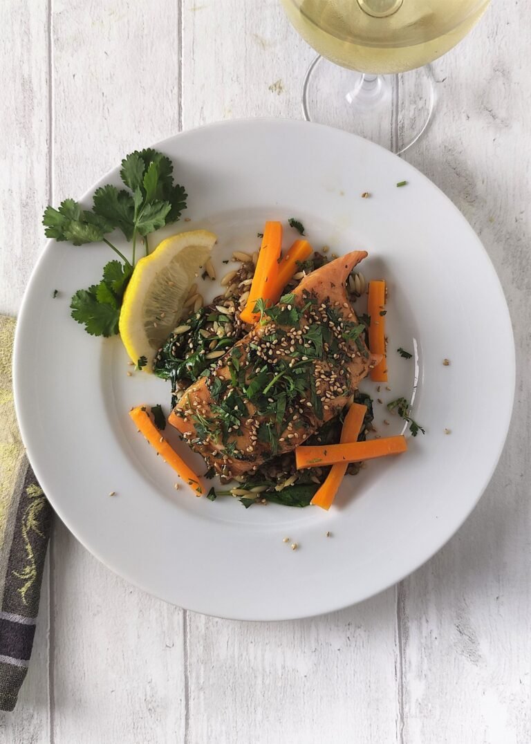 Grilled Salmon With Honey, Ginger & Lime Glaze on a white plate served with carrots