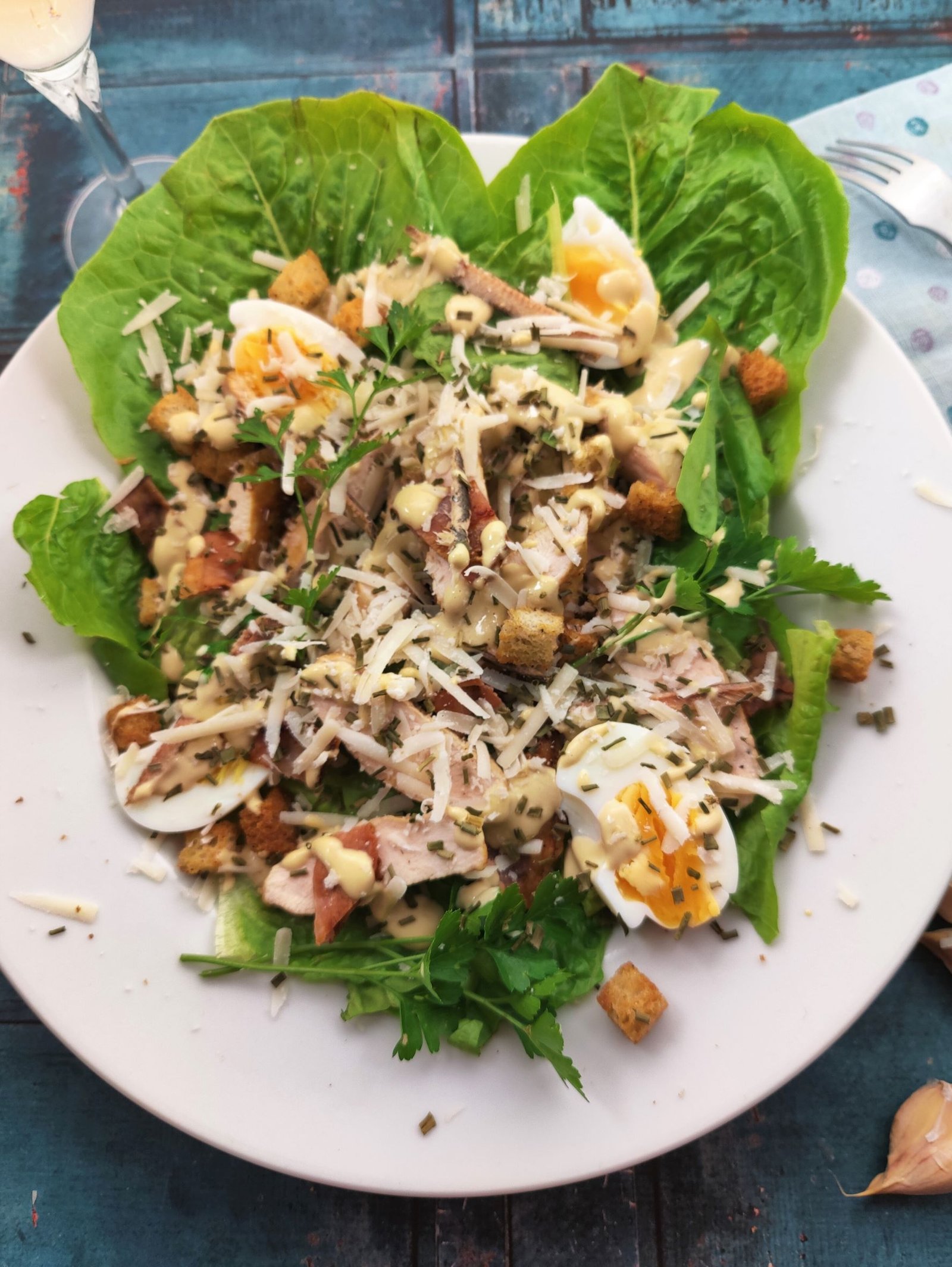 Caesar Salad with Chicken and Bacon on a white plate