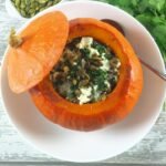 Roasted vegetarian stuffed pumpkin with seeds for a high-zinc eye health meal.