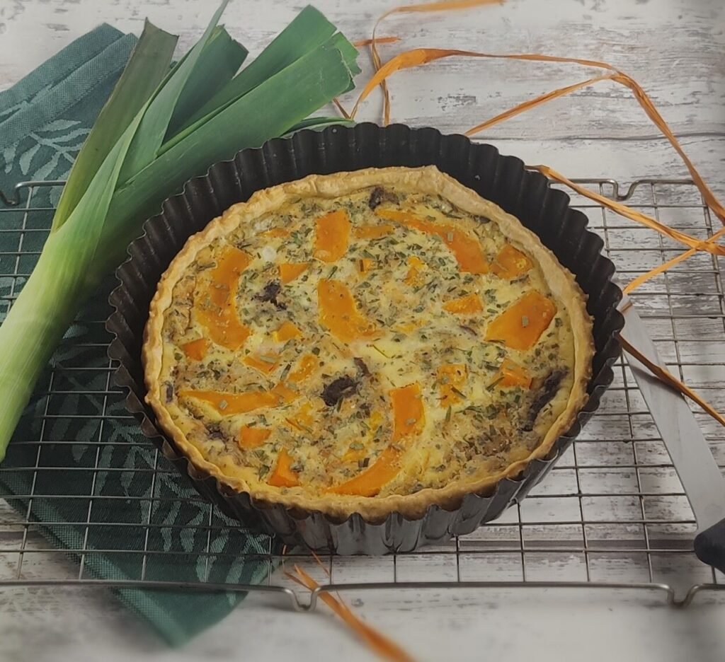 pumpkin and gorgonzola tart on a cooling rack with leek