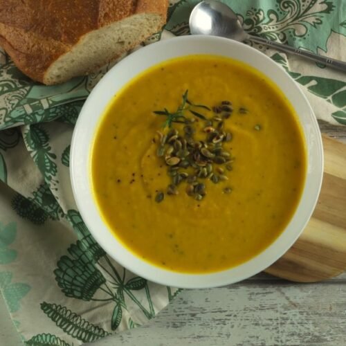 Cream of Butternut Soup with toated pumpkin seeds on top served with crusty bread