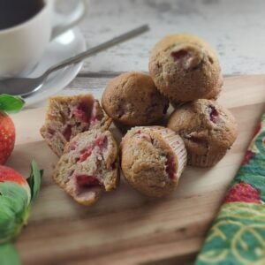 close-up of freshly baked strawberry muffins showcasing their golden-brown tops and juicy strawberry pieces