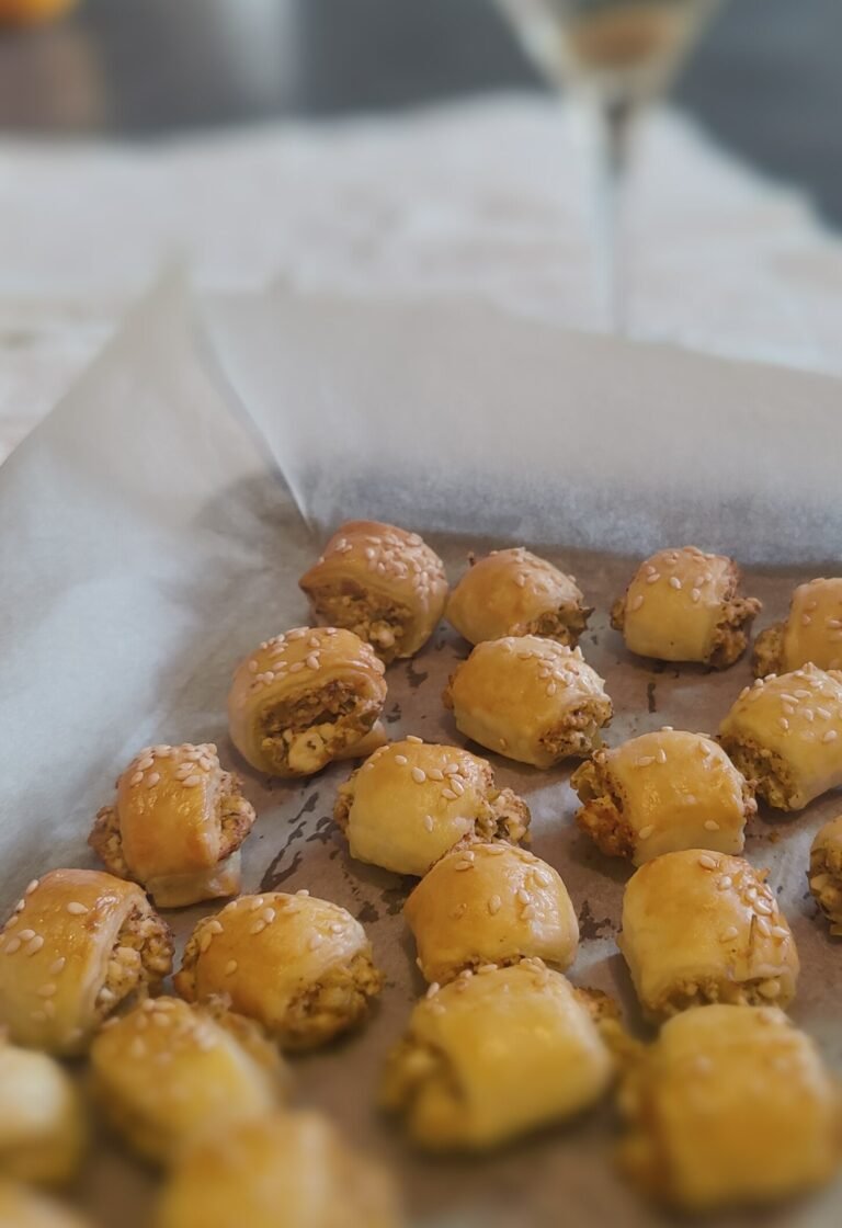 Cheese and olive rolls with a martini