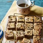 no bake healthy breakfast bars recipe with coconut banana dates and oats on wooden cutting board