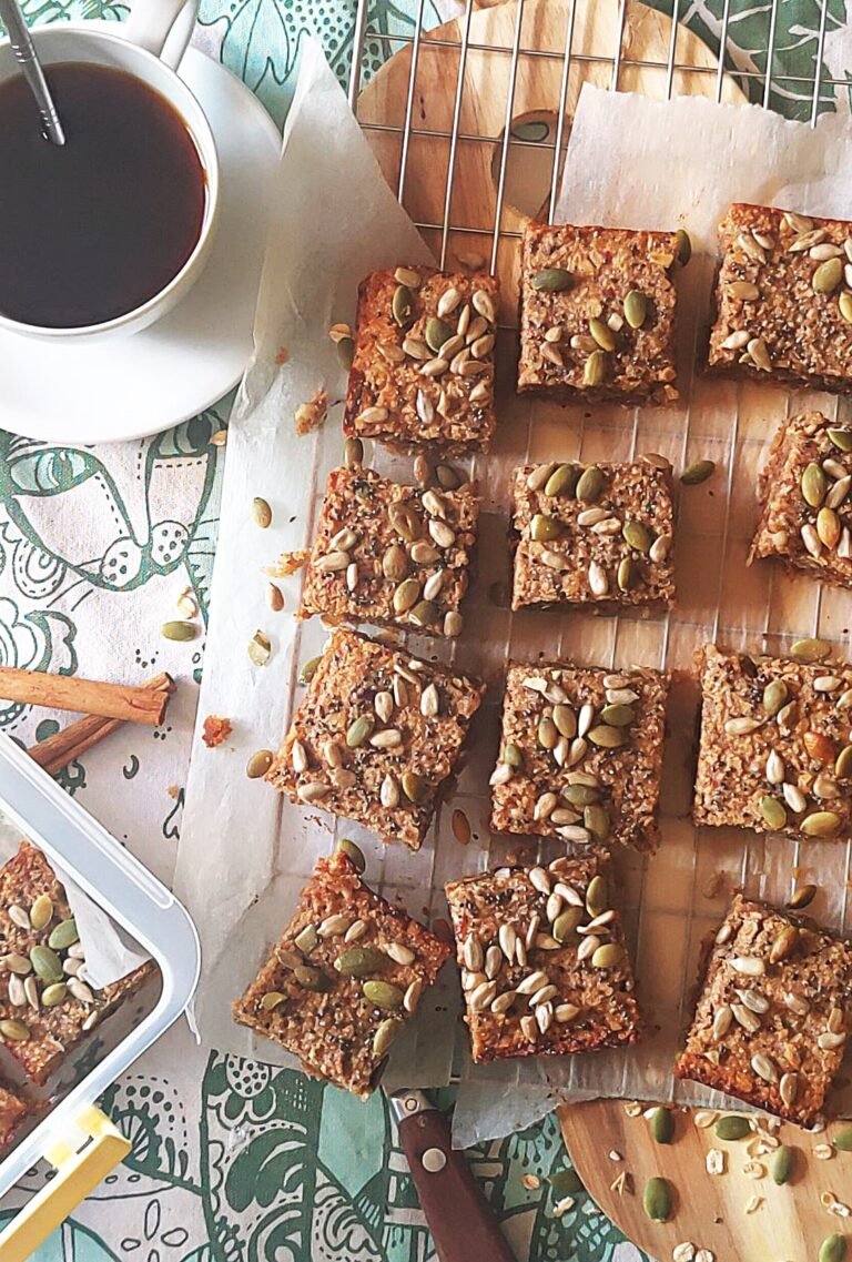 homemade healthy breakfast bars recipe featuring coconut banana and dates served on rustic wooden cutting board alongside cup of coffee