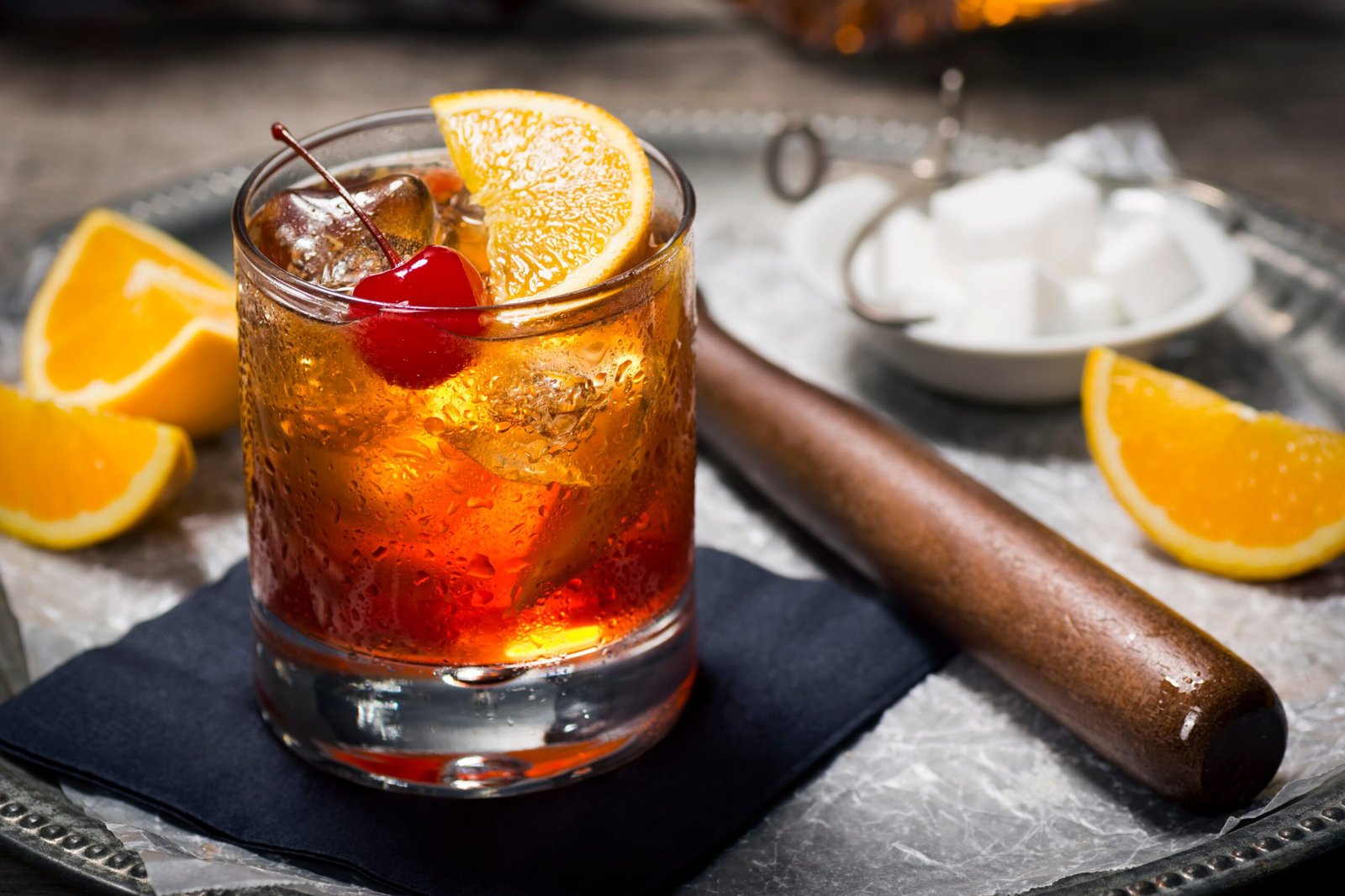 Old Fashioned cocktail in a glass garnished with an orange slice and cherry