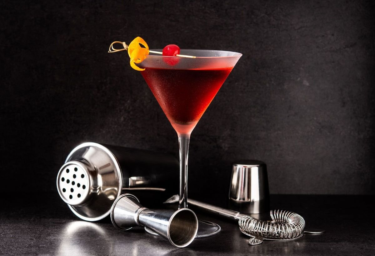 Manhatten cocktail with a cherry garnish in a martini glass- maisonbonhomie