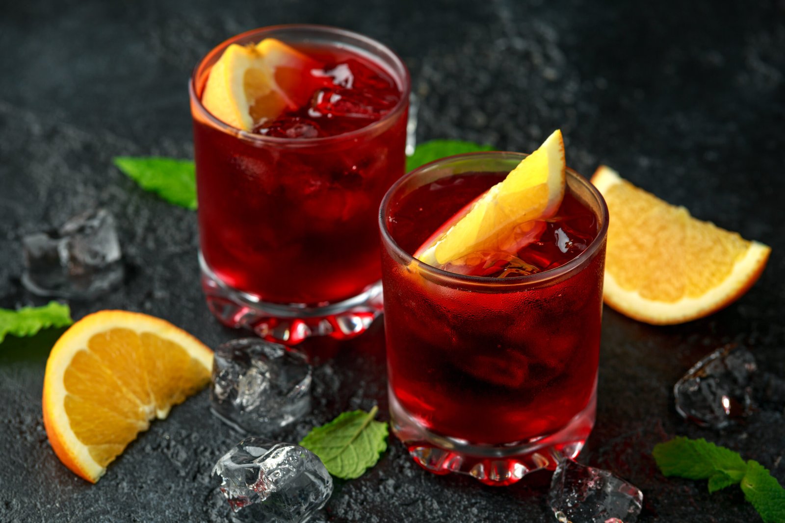 Classic Negroni cocktail on rustic stone background.