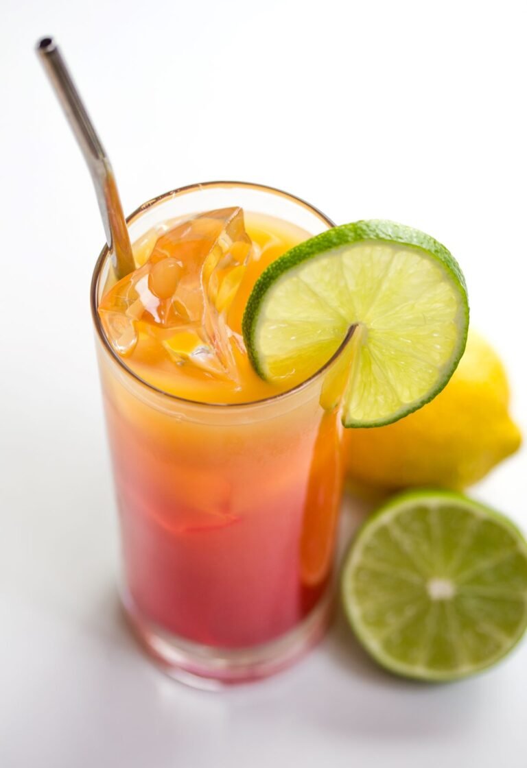 tequilla sunrise cocktail with lime garnish