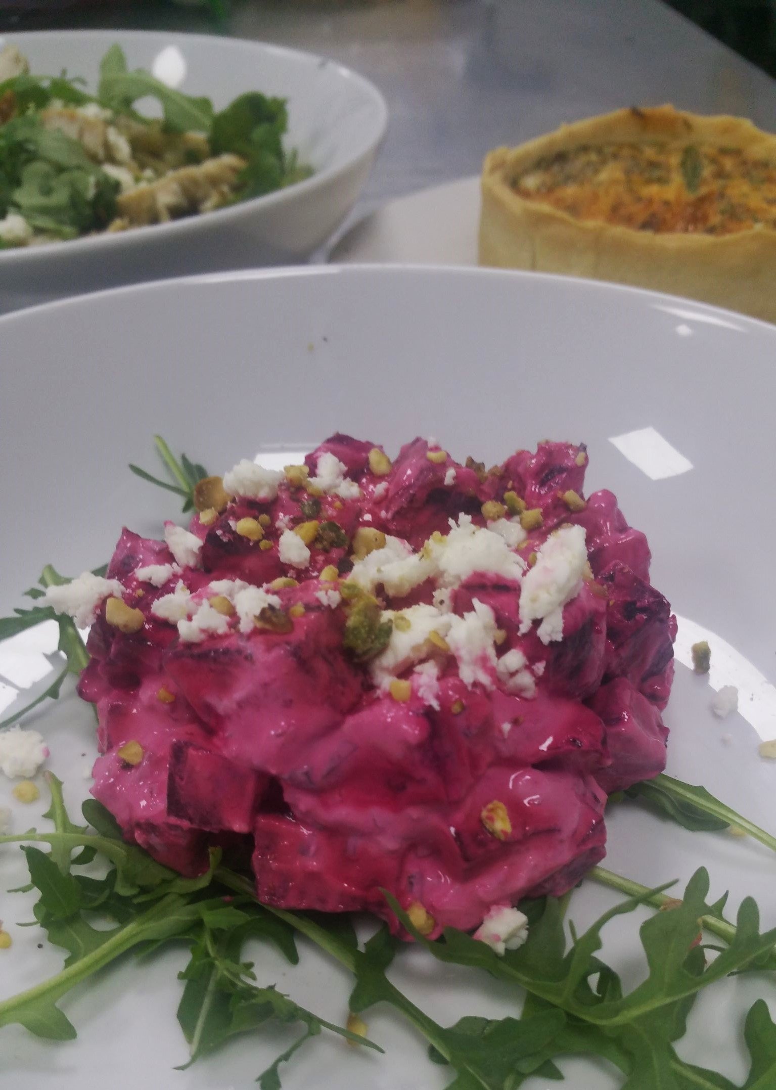 Beet Root & Feta Salad with creamy dressing on rocket and garnished with crushed pistachio