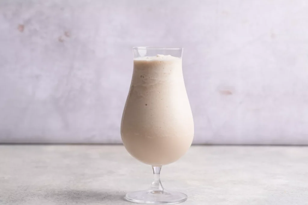 the Bushwacker cocktail in a tall glass on a table