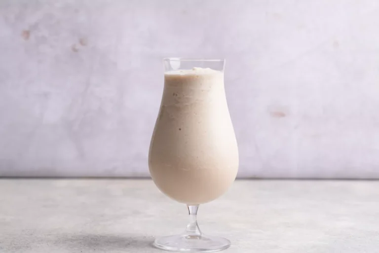 the Bushwacker cocktail in a tall glass on a table