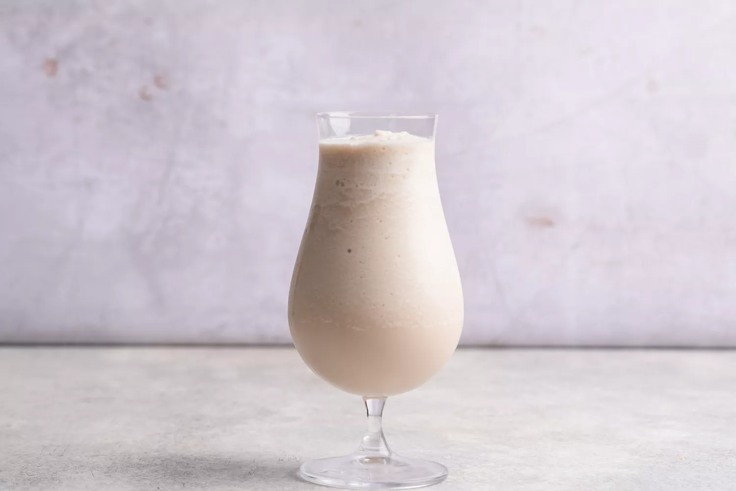 the Bushwacker cocktail in a tall glass on a table