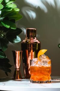 a digestif of Drambuie in a rocks glass with ice and garnished with a sice of orange