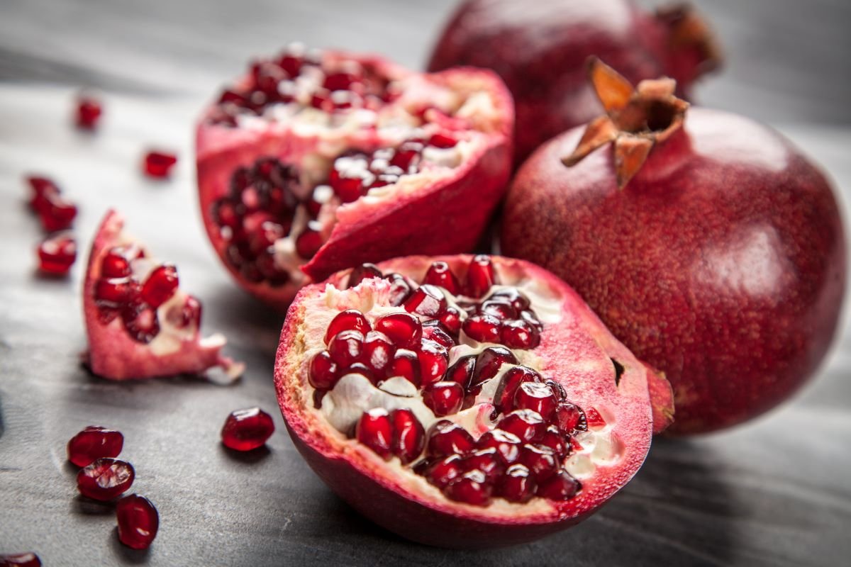 cut pomegranate showing superfood seeds for skin health