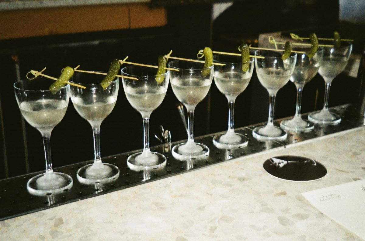 best gin drinks on a bar garnished with piclke